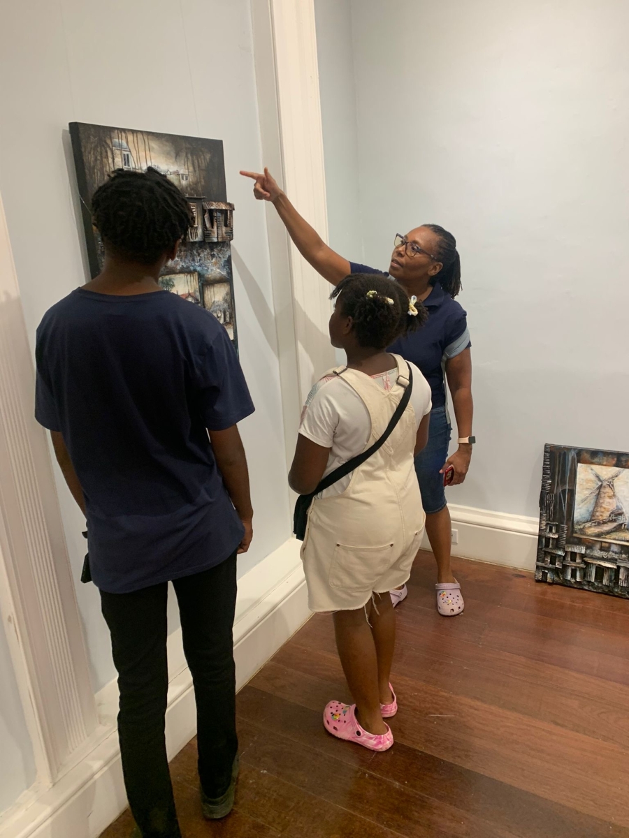 The Fredericks family engage with Barbadian artwork at Queen's Park Galery earlier this year. They are tackling the 4LB questions as a family. [Photo: Linda M. Deane].